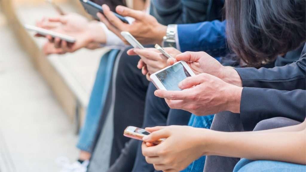 Workers sitting down and on their phones