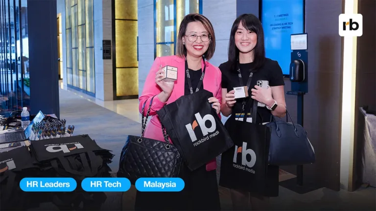 2 HR malaysia attendees posing with their rockbird media merch