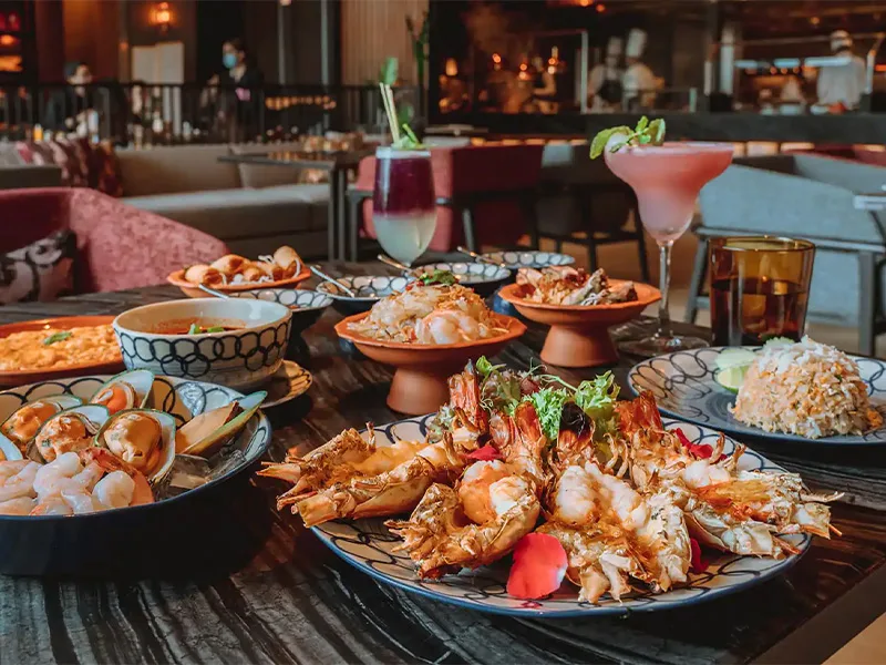 Multiple seafood platters and cocktails on a table