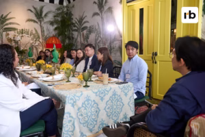 A group of people engaged in discussion around a table filled with breakfast food during a roundtable on loyalty marketing.
